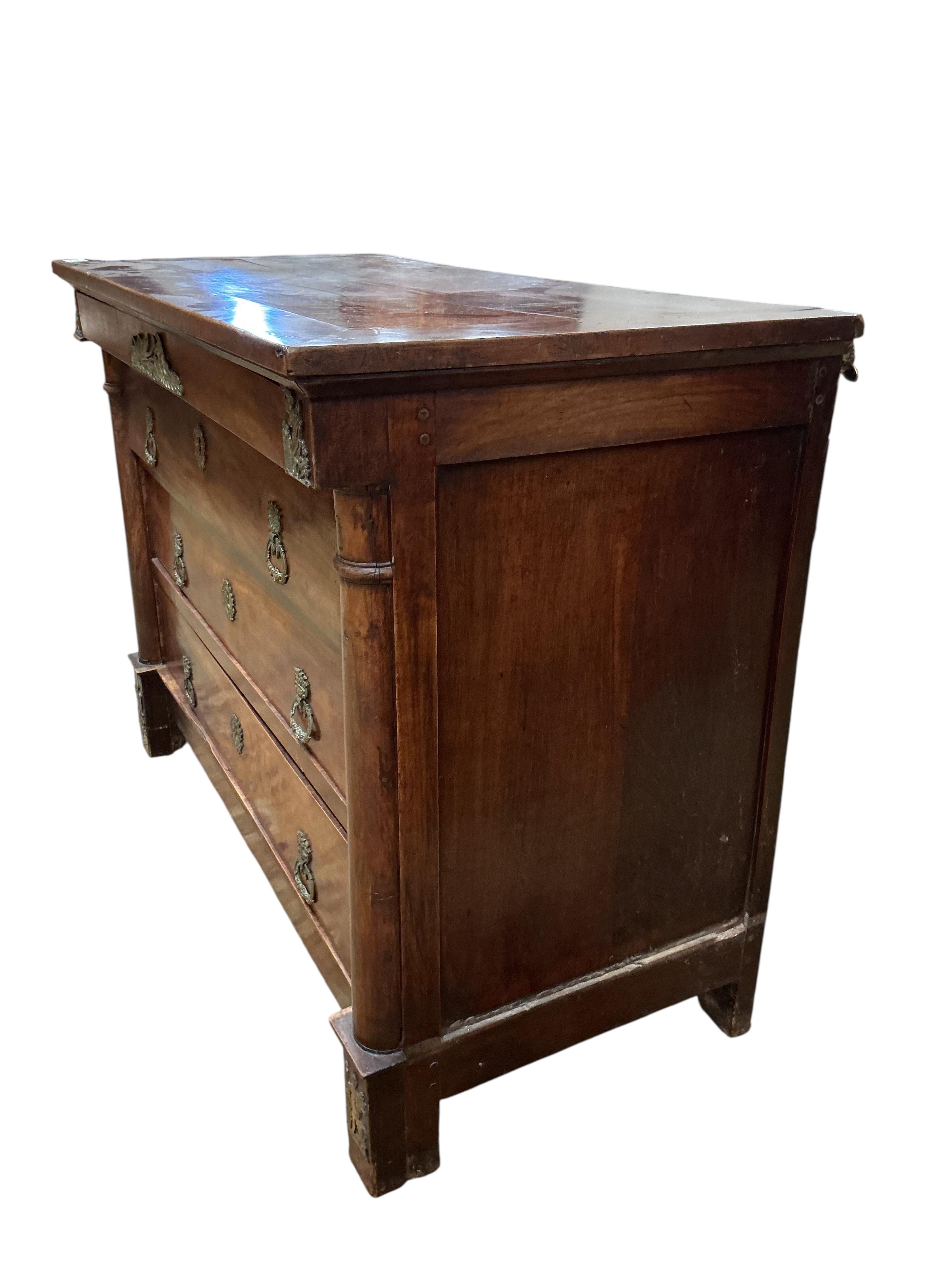 An early 19th century French ormolu mounted cherry commode, fitted four long drawers, width 117cm, depth 56cm, height 87cm